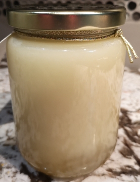 Close up of jar of white honey